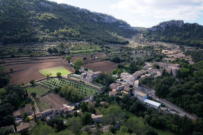 High angle view of trees and buildings on field