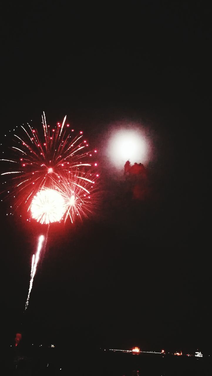 firework display, firework - man made object, exploding, night, celebration, arts culture and entertainment, sparks, smoke - physical structure, illuminated, event, low angle view, long exposure, sky, firework, glowing, motion, outdoors, red, blurred motion, no people, multi colored