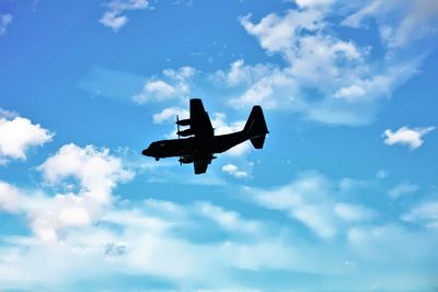 Low angle view of airplane flying in sky