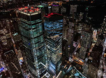 Aerial view of illuminated buildings in city at night