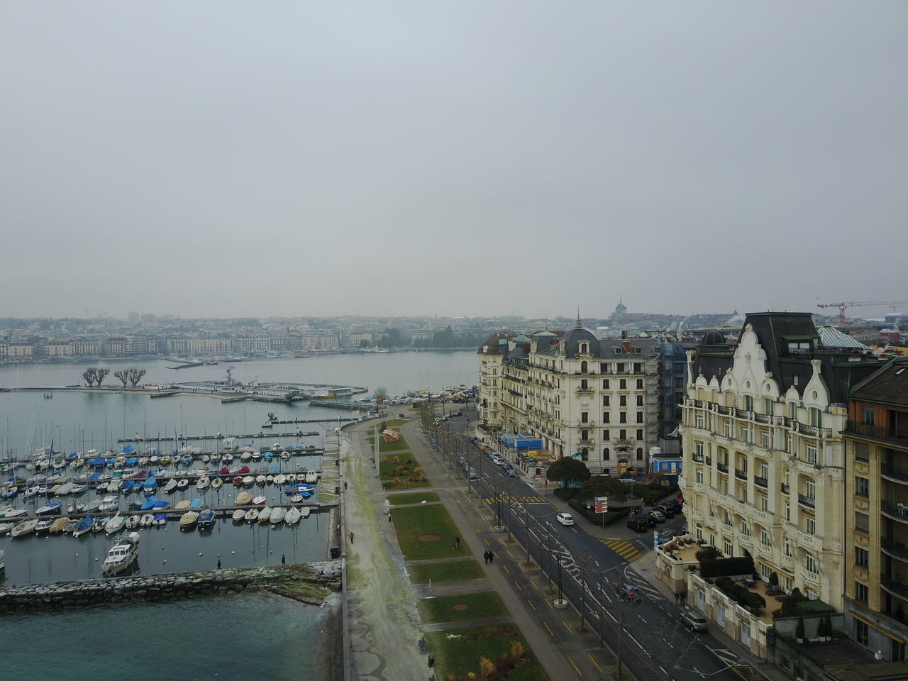 HIGH ANGLE VIEW OF ROAD BY BUILDINGS IN CITY