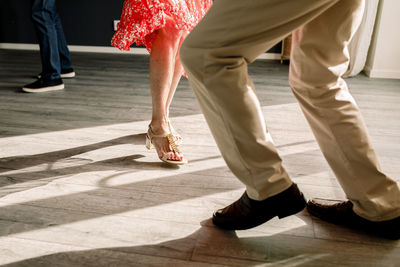 Low section of senior man and woman practicing dance in class