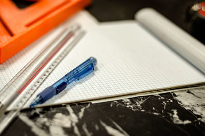 Close-up of paper and pen on table