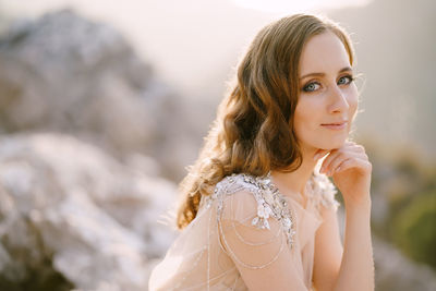 Portrait of beautiful young woman standing outdoors