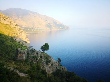 High angle view of sea and mountains against sky