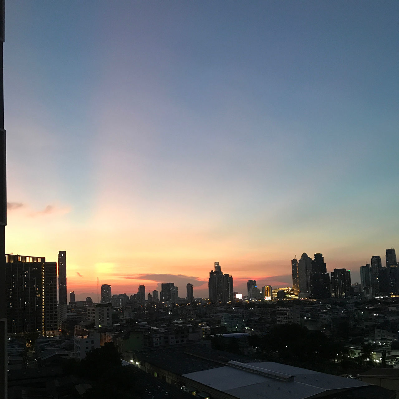 MODERN BUILDINGS AGAINST SKY DURING SUNSET