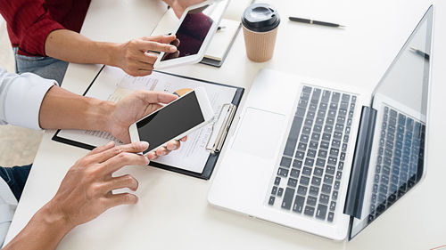 Low angle view of people working on table