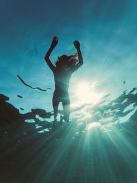 Low angle view of woman swimming in sea