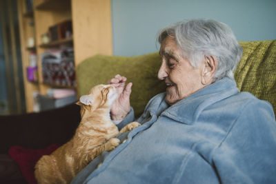 Side view of man with cat