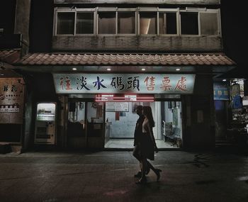 Rear view of woman walking at railroad station