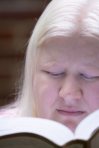 Close-up of woman reading book