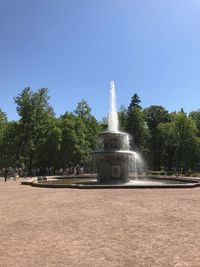 Fountain in park against clear sky