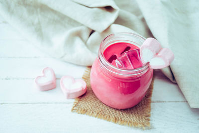 High angle view of pink roses in jar on table