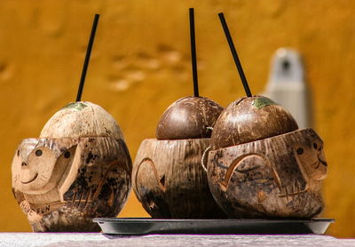 Close-up of fruits on table against wall