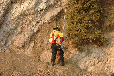 Full length of man with dog on rock