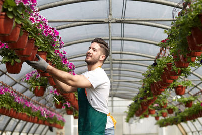 Young man standing in greenhouse