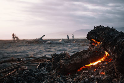 Close-up of bonfire against sky during sunset