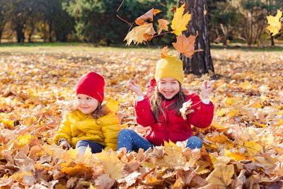 Cheerful girls talking while standing outdoors