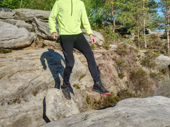 Man athlete while jumping during a trail running in the mountains. active lifestyle and adventure