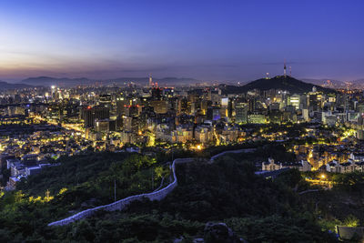 High angle view of illuminated buildings in city at night