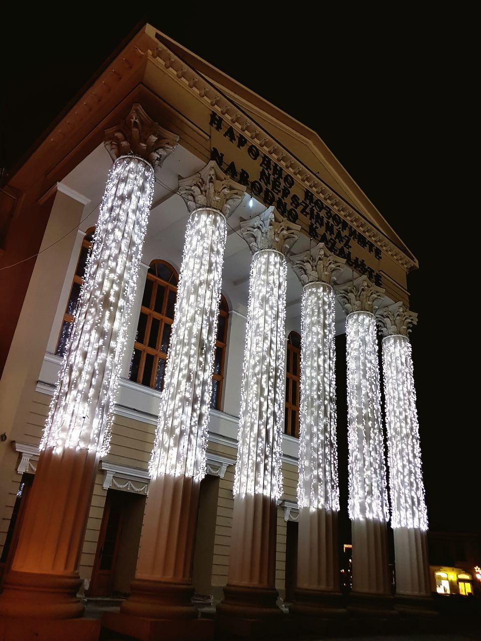 LOW ANGLE VIEW OF ILLUMINATED BUILDING