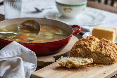 Close-up of soup and damper served on the table