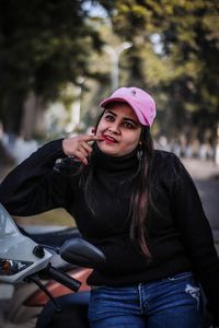 Portrait of beautiful woman standing in car