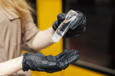 Close-up of woman holding bottle