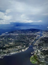 High angle view of buildings by sea against sky