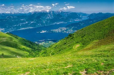 Scenic view of field and mountains against sky