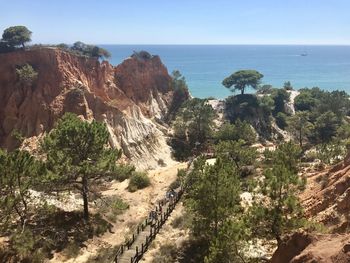 Scenic view of sea and mountains against sky