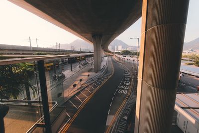 Train on bridge over road in city