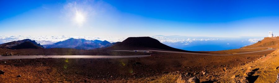 Scenic view of snowcapped mountains against blue sky