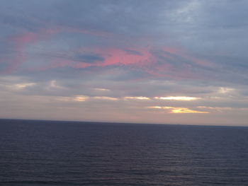 View of calm sea against cloudy sky