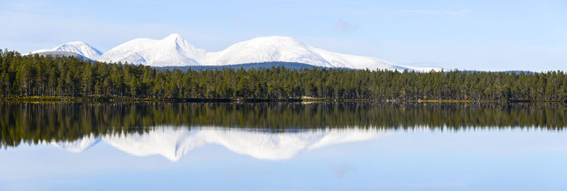 Snow covered mountains with lake in the foreground