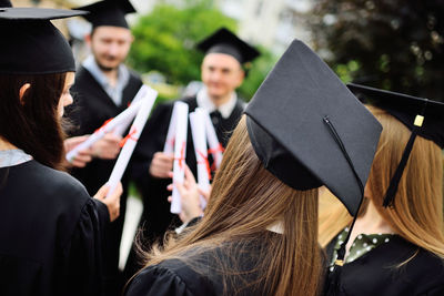 Rear view of woman wearing graduation gown