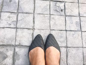 Low section of woman in black shoe