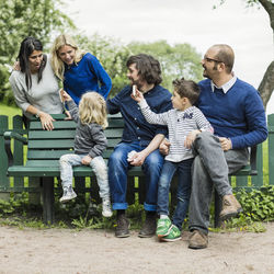 Homosexual families spending leisure time in park