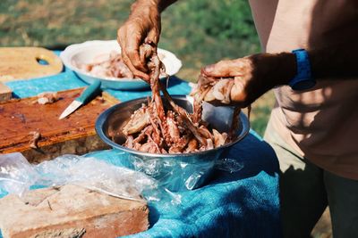 Cropped hand of man preparing food