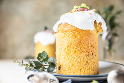 Kulich. traditional orthodox easter sweet bread decorated with meringue icing and candy shaped eggs