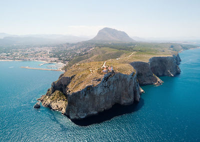 High angle view of rocks on sea shore against sky