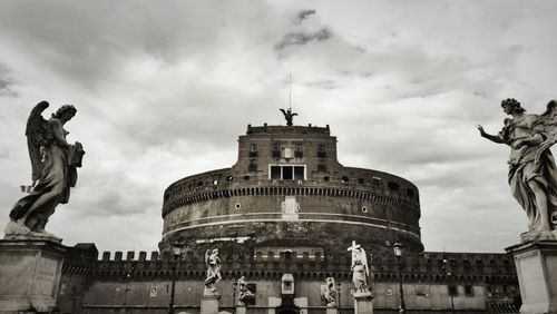 Low angle view of castel santangelo against cloudy sky