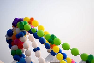 Low angle view of balloons against sky