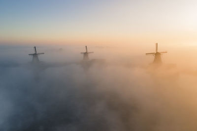 Windmills in foggy weather