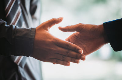 Colleagues shaking hands in office