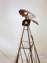 Low angle view of traditional windmill against sky