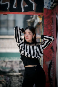 Portrait of a young woman standing outdoors