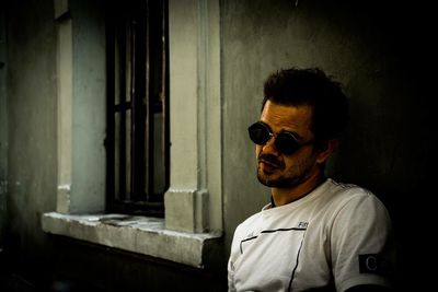 Portrait of young man wearing sunglasses standing outdoors