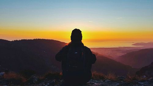 Silhouette of woman at sunset