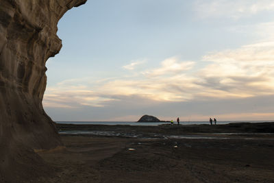 Scenic view of beach against sky during sunset